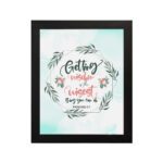 Proverbs 4:7 Bible verse wall art with green leaf wreath and red flowers, perfect for Christian home decor. hung on the wall in a black frame