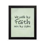 We Walk By Faith Not By Sight Bible Verse Wall Art on a mint green background. hung on the wall in a black frame