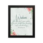 Christian wall art with Proverbs 2:6, featuring "Wisdom" and floral accents on a cream background. hung on the wall in a black frame