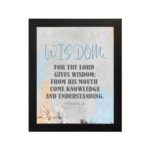 Christian wall art displaying Proverbs 2:6 with a blue gradient background and the word "Wisdom" in elegant lettering. hung on the wall in a black frame