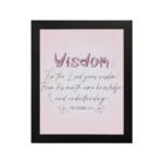 Christian wall art with the quote from Proverbs 2:6, featuring the word "Wisdom" in script on a soft pink background. hung on the wall in a black frame