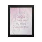 Christian wall art featuring Psalm 56:4, with soft pink background and elegant script font. Perfect for home decor. hung on the wall in a black frame