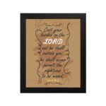 Christian wall art featuring Psalm 55:22, with a warm brown background, dark text, and elegant scrollwork. Perfect for home decor. hung on the wall in a black frame