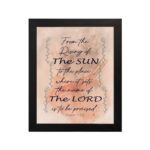 Bible wall art featuring Psalm 113:3 with floral elements and stylish text on a peach background. hung on the wall in a black frame