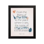 Bible verse wall art displaying From the Rising of the Sun to the Place Where It Sets, The Name of the Lord Is to Be Praised. hung on the wall in a black frame