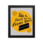 Infidu Take A Small Step Everyday wall art with a gray and yellow background black text and black frame hung on the wall. Inspiring decor for any workspace.