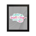 Infidu Take A Small Step Everyday wall art with a gray background and vibrant green, yellow, and pink text and black frame hung on the wall. Inspiring decor for any workspace.