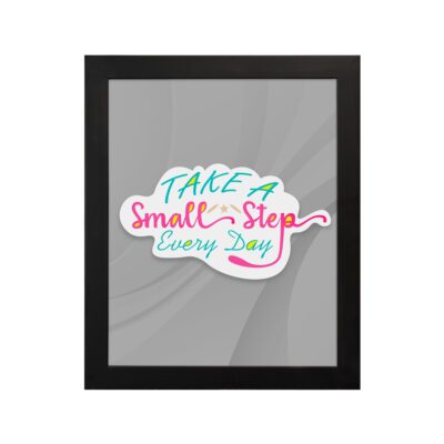 Infidu Take A Small Step Everyday wall art with a gray background and vibrant green, yellow, and pink text and black frame hung on the wall. Inspiring decor for any workspace.