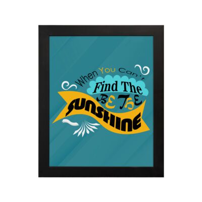 Infidu When You Can't Find the Sunshine, Be the Sunshine Office Wall Art featuring black, yellow, and blue text on a light blue background with decorative elements, framed in black hung on the wall. Perfect for inspirational quote wall art, office wall art, and home decor.