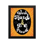 Work Hard Be Proud office wall art with white text on a black effect background gradient of orange and yellow, framed in black hanging on the wall. Perfect for home office decor.