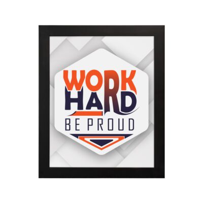 Inspirational quote wall art featuring Work Hard Be Proud with orange and navy blue text on a light gray and light green background and black frame hung on the wall. Perfect for home offices.