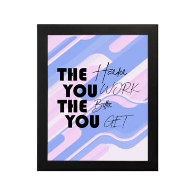 Infidu motivational quotes wall decor featuring The Harder You Work The Better You Get on a mixed white, pink, and navy blue background on the table. Perfect for inspiring your workspace.