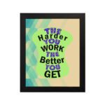 Infidu The Harder You Work The Better You Get wall art with a sandal-colored background green design, and black frame hung on the wall. Inspiring decor for home offices and workspaces.