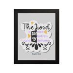 Bible wall art with The Lord Is My Rock, My Fortress, and My Deliverer in colorful pastel text on a light grey background with decorative elements. hung on the wall in a black frame