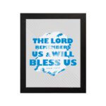 Wall art featuring the text The Lord Remembers Us And Will Bless Us in bold blue on a soft gray background. hung on the wall in a black frame