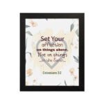 Colossians 3:2 Bible verse wall art with floral design and bold lettering, featuring the words Set Your Affection on Things Above. hung on the wall in a black frame