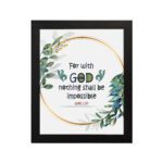 Wall art featuring the quote With God Nothing Shall Be Impossible from Luke 1:37, surrounded by a golden frame and green leaves. hung on the wall in a black frame