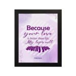 Bible wall art featuring Psalm 63:3 with playful text in purple and pink on a lavender background. hung on the wall in a black frame