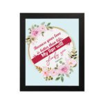 Beautiful wall art with the quote Because your love is better than life from Psalm 63:3, featuring a floral design on a light blue background. hung on the wall in a black frame