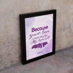 Bible wall art featuring Psalm 63:3 with playful text in purple and pink on a lavender background. displayed on the wall in a black frame