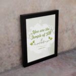 Christian wall art featuring 'You Are The Temple of God His Spirit Dwells in You' from 1 Corinthians 3:16 with green and gray design. displayed on the wall in a black frame