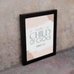 Bless The Lord O My Soul Psalm 103:1 Christian wall art with soft gray and peach tones, elegant font, and abstract brushstroke background. displayed on the wall in a black frame