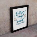 Proverbs 4:7 Christian wall art with elegant script and floral design, featuring Getting Wisdom Is The Wisest Thing You Can Do. displayed on the wall in a black frame