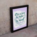 Christian wall art with Getting Wisdom Is The Wisest Thing You Can Do Proverbs 4:7, green text, light purple background, and decorative swirls. displayed on the wall in a black frame