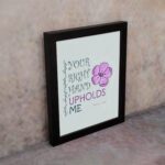 Your Right Hand Upholds Me Psalm 63:8 Christian Wall Art with bold text and floral design on a mint green background. displayed on the wall in a black frame