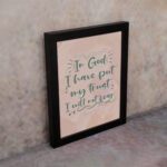 Wall art featuring the quote In God I Have Put My Trust I Will Not Fear from Psalm 56:4 in a bold, playful font. displayed on the wall in a black frame