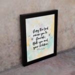 Christian wall art featuring Psalm 115:14 in black cursive on a pastel watercolor background with floral designs. displayed on the wall in a black frame