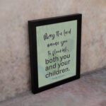 Christian wall art with Psalm 115:14 Bible verse on a light green and gray background with black font and black frame on the wall