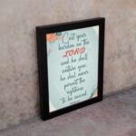 Cast Your Burden on the Lord Psalm 55:22 Christian wall art with teal and coral text on a mint green background with floral accents. displayed on the wall in a black frame