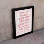 Bible wall art featuring Psalm 113:3 with bold text and a soft pink background, highlighting The Sun and The Lord. displayed on the wall in a black frame