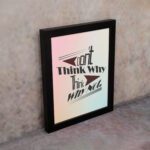 Infidu Don't Think Why, Think Why Not wall art with a red flower design a light blue, gray, and light pink background, and a black frame on the wall. Inspiring decor for home offices and workspaces.