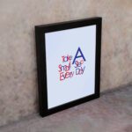 Infidu Take A Small Step Everyday wall art with a gray background navy blue and red text and a black frame on the wall. Inspiring decor for any workspace.