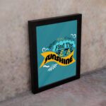 Infidu When You Can't Find the Sunshine, Be the Sunshine Office Wall Art featuring black, yellow, and blue text on a light blue background with decorative elements, framed in black on the wall. Perfect for inspirational quote wall art, office wall art, and home decor.