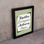 Infidu motivational quotes wall art featuring Together Everyone Achieves More on a light gray and light green background and black frame on the wall. the inspiring teamwork