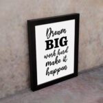 Infidu motivational quotes wall art featuring Dream Big Work Hard Make It Happen on a white background and black frame on the wall. Perfect for inspiring your workspace.