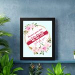 Beautiful wall art with the quote Because your love is better than life from Psalm 63:3, featuring a floral design on a light blue background. displayed on the wall in a black frame