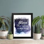 Bless The Lord O My Soul Psalm 103:1 Christian wall art with white text on a deep blue watercolor background. displayed on the table in a black frame