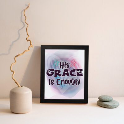 His Grace Is Enough Christian wall art with bold dark purple text and a soft gradient background in pink, purple, and blue. displayed on the wall in a black frame