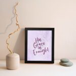 His Grace Is Enough Bible Wall Art with purple text on a lilac background. displayed on the wall in a black frame