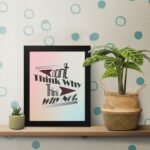 Infidu Don't Think Why, Think Why Not wall art with a red flower design a light blue, gray, and light pink background, and a black frame on the table. Inspiring decor for home offices and workspaces.