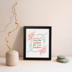 Infidu When You Can't Find The Sunshine Be The Sunshine wall art with a white background and red floral accents and black frame displayed on the wall Inspiring decor for home offices.