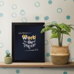 Infidu Work Hard Be Proud office wall art featuring motivational quotes on a navy blue background and black frame on the table. Perfect for home offices and study areas.