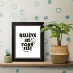 Inspirational quote wall art featuring Believe In Yourself on a white background on the table. Perfect for motivating your home office.