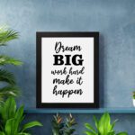 Infidu motivational quotes wall art featuring Dream Big Work Hard Make It Happen on a white background and black frame hung on the wall. Perfect for inspiring your workspace.