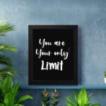 Infidu motivational quotes wall art featuring You Are Your Only Limit on a dark black background and black frame hung on the wall. Perfect for inspiring your workspace.