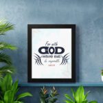 Infidu Bible wall art featuring the quote With God Nothing Shall Be Impossible in navy blue text on a light blue watercolor background. displayed on the wall in a black frame